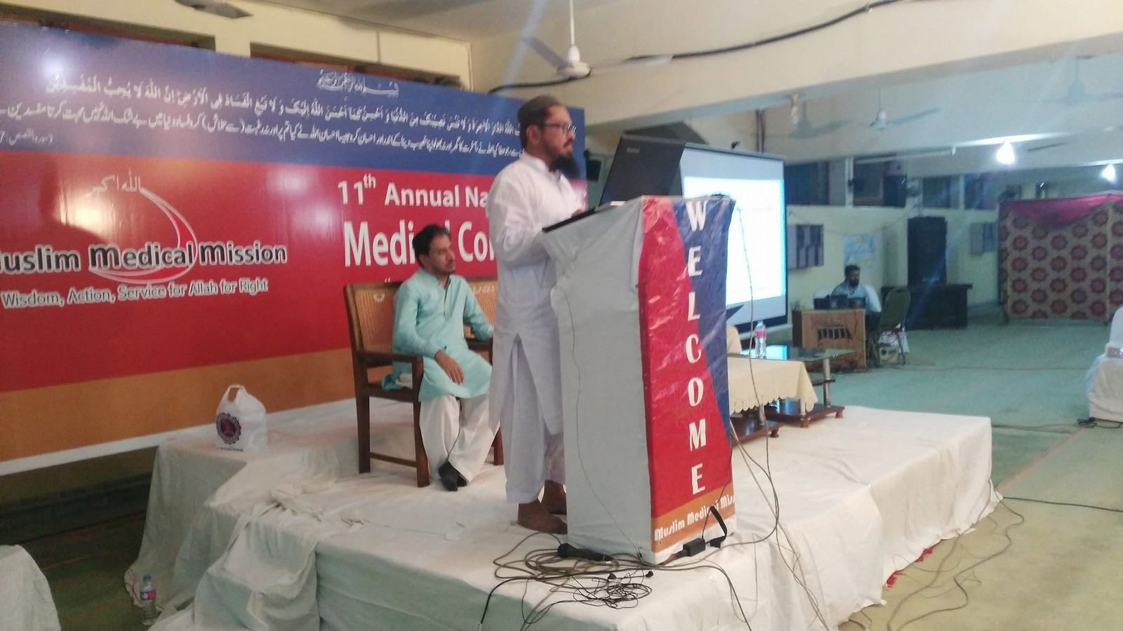 Audience and delegates gathered at the Muslim Medical Mission National Medical Conference with grand official stage banner